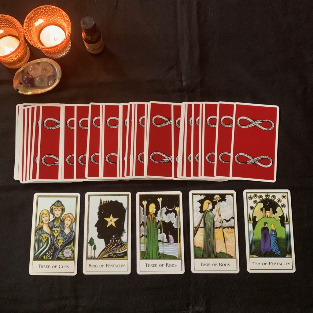 Card backs, Three of Cups, King of Pentacles, Three of Rods, Page of Rods, and Ten of Pentacles. The New Palladini Tarot